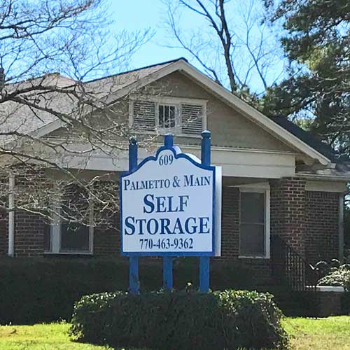 indoor climate controlled storage units with roll-up doors inside of a clean, well-lit building