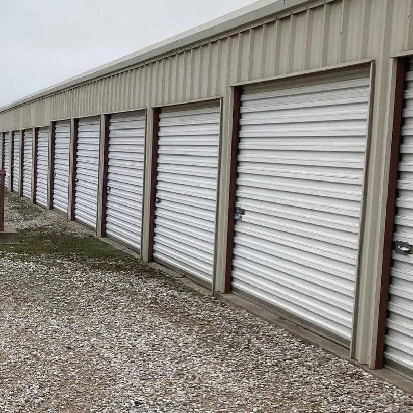 indoor climate controlled storage units with roll-up doors inside of a clean, well-lit building